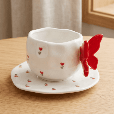 كوب سيراميك بنقوش قلوب حمراء صغيرة مع مقبض على شكل فراشة  & : Ceramic Mug with Small Red Heart Pattern and Butterfly-Shaped Handle