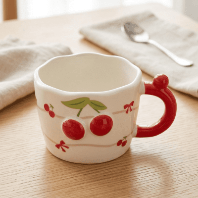 كوب سيراميك بتصميم الكرز البارز مع تفاصيل الأشرطة &  Ceramic Mug with Embossed Cherry Design and Ribbon Details