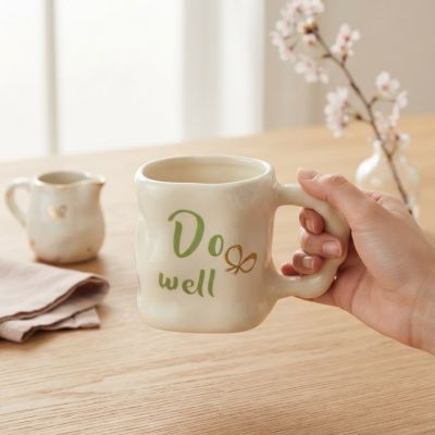 كوب سيراميك يدوي الصنع بعبارة "Do well" ونقشة فيونكة ذهبية.  & : Handmade Ceramic "Do well" Mug with Gold Bow Accent.
