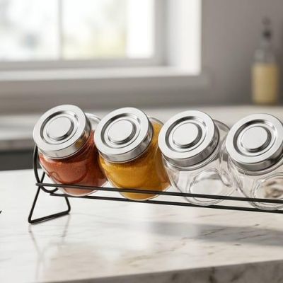 practical 4-piece spice set with glass jars and a sturdy metal holder. Perfect for storing and organizing your favorite spices while adding a modern touch to your kitchen