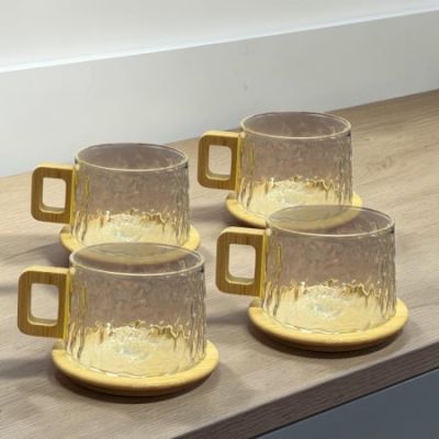 Elegant Ripple-Glow Glass Tea & Coffee Mug Set (4-Piece) Add a touch of warm, organic minimalism to your morning routine with this stunning 4-Piece Ripple Glass Mug Set. Blending natural textures with modern geometric lines, these unique cups are desi