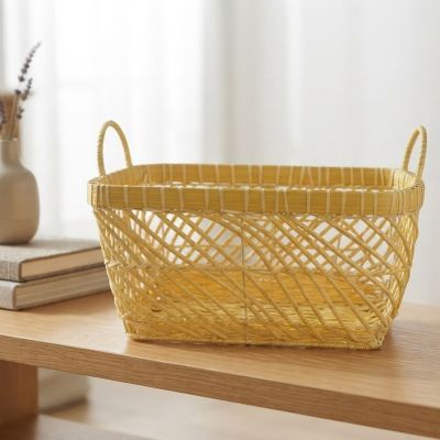 سلة تنظيم وتخزين خيزران/بلاستيك مقوى باللون الأصفر مزودة بمقابض جانبية.  English: Yellow Woven Storage Basket with Side Handles.