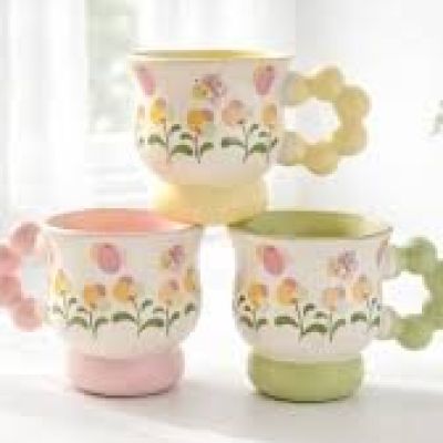 pastel-colored porcelain mug featuring a floral pattern and a bubble-textured handle.
