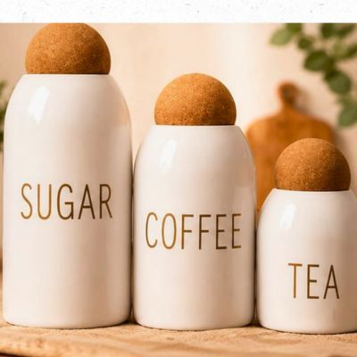 ☕ Coffee, Tea & Sugar Canisters Modern ceramic canisters with cork lids to keep contents fresh. Material: Ceramic & Natural Cork Use: Coffee, Tea & Sugar Storage Design: Clean & Space-Saving Origin: Imported