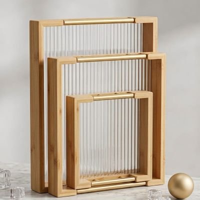 Bring timeless organization to your home with this sophisticated set of three nesting bamboo trays. Designed with elegant gold-tone handles, they offer the perfect blend of natural texture and modern luxury for serving or display. ✨