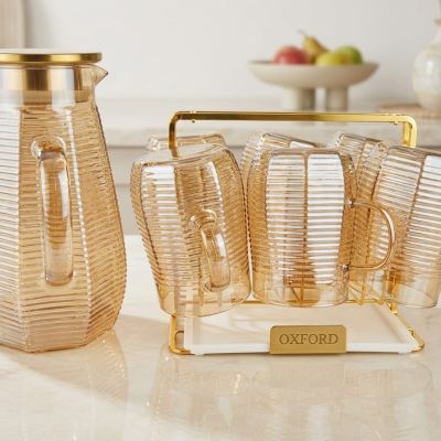 Add a touch of warmth to your table. 🥂 This stunning ribbed glass set is the perfect balance of modern design and timeless elegance. Elevate your serving collection today."